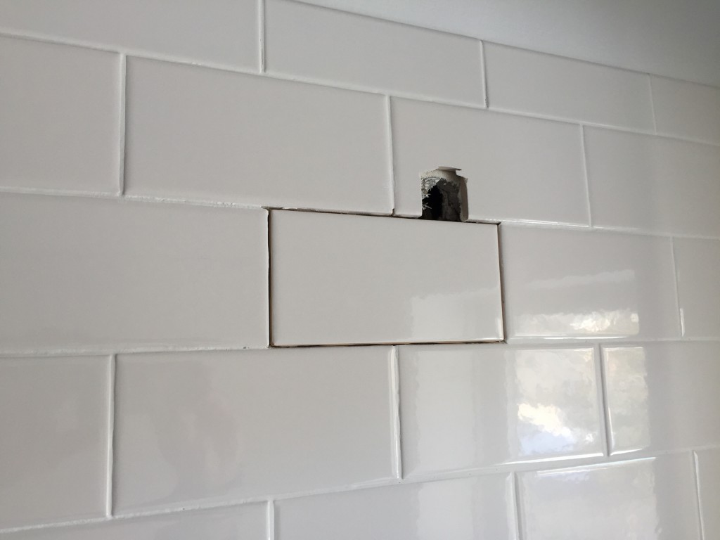 Tile was removed from property by Greg Truskey before the tiler completed the work.  This tile was added in by Greg Truskey  but no grout.