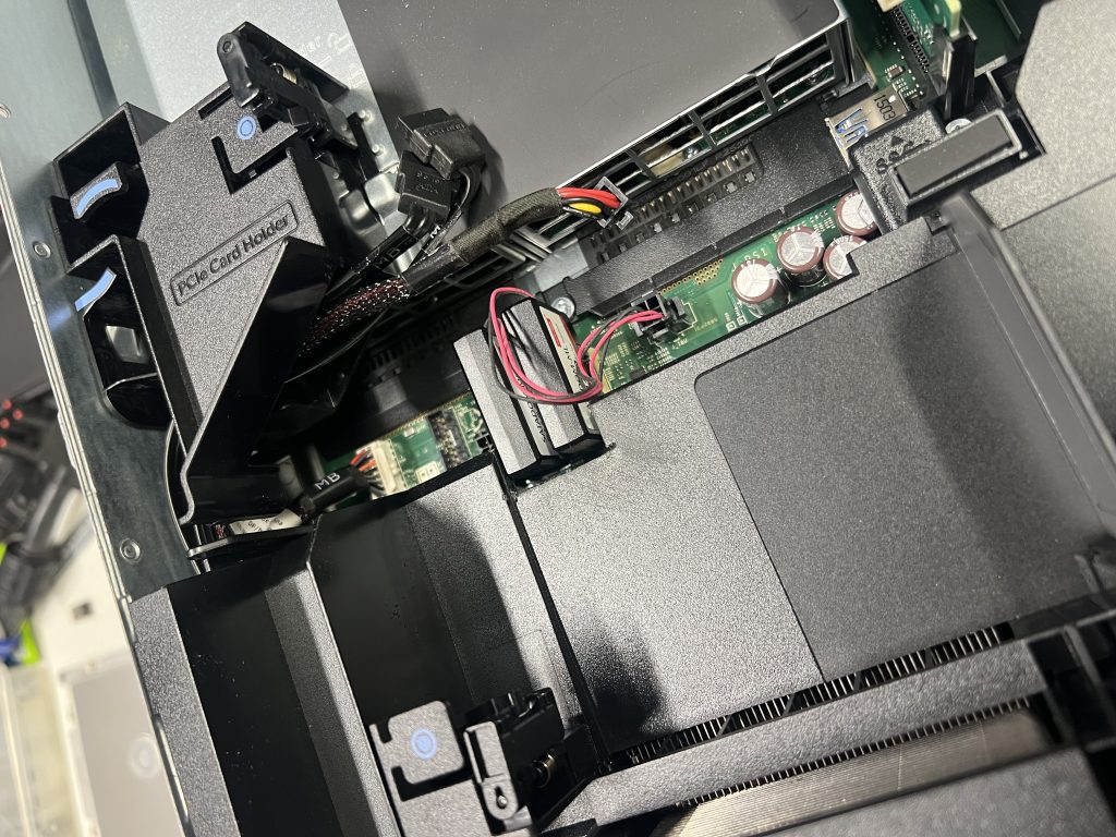 Loose cables moved more to the rear of the case. SATADOM power cables are moved away from the heatsink under the cowl.